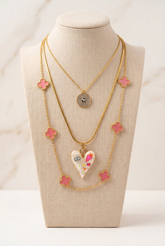 Layered necklace bundle: pink clover chain, evil eye pendant, heart pendant